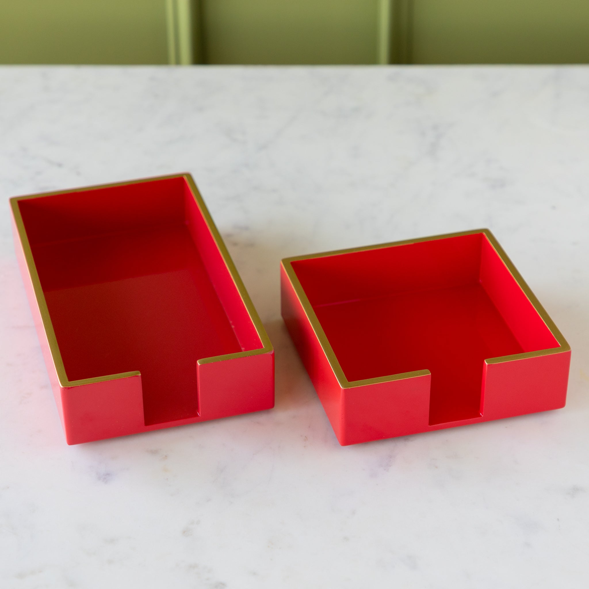 Two Beverage Napkin Holders in red with gold trim in cocktail and a guest size.
