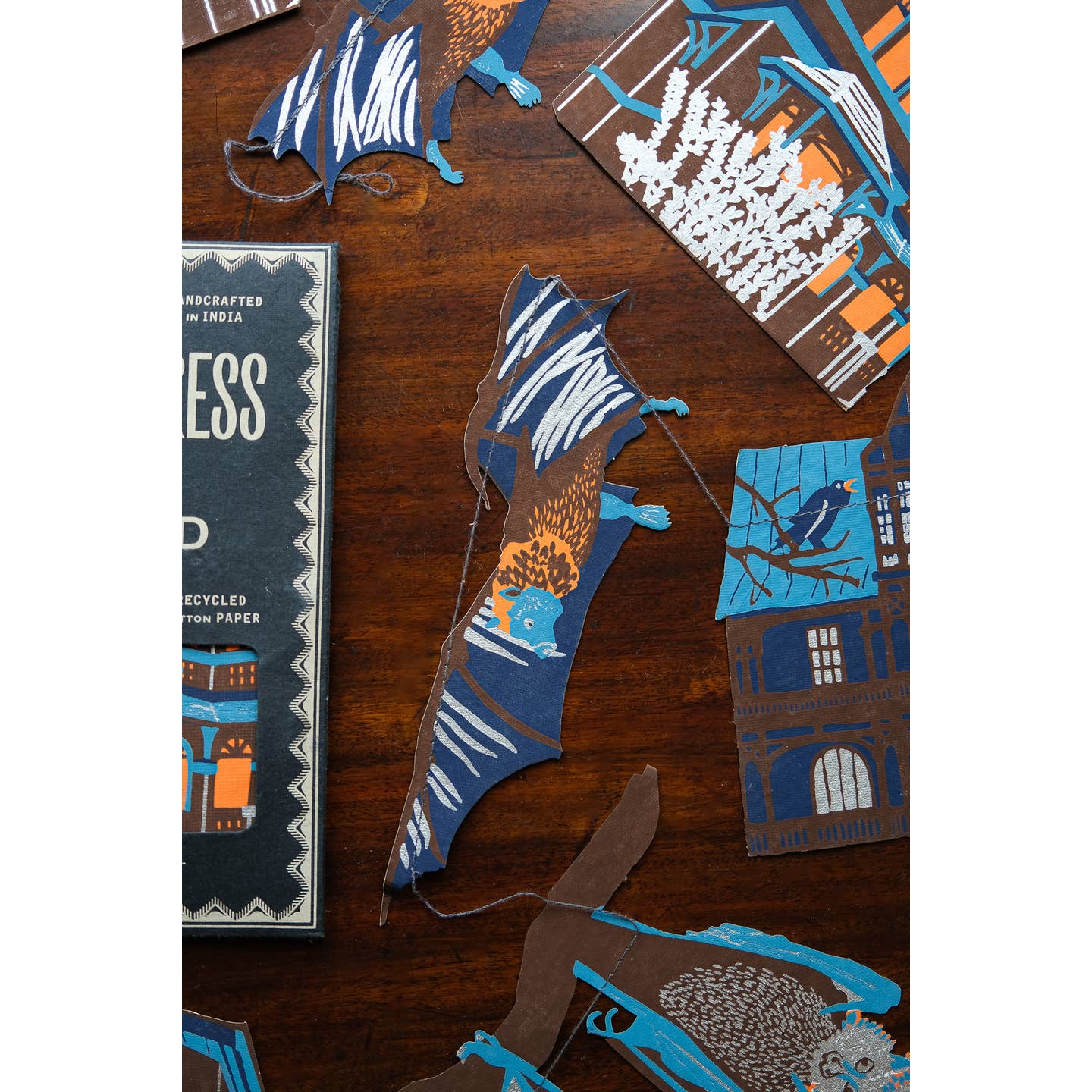 Package of the Haunted House sewn garland on a table surrounded by the garland.