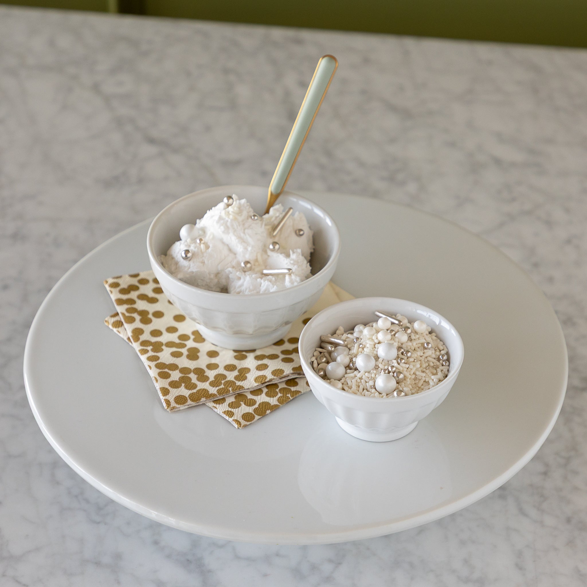 White fluted bowls with ice cream in them. 
