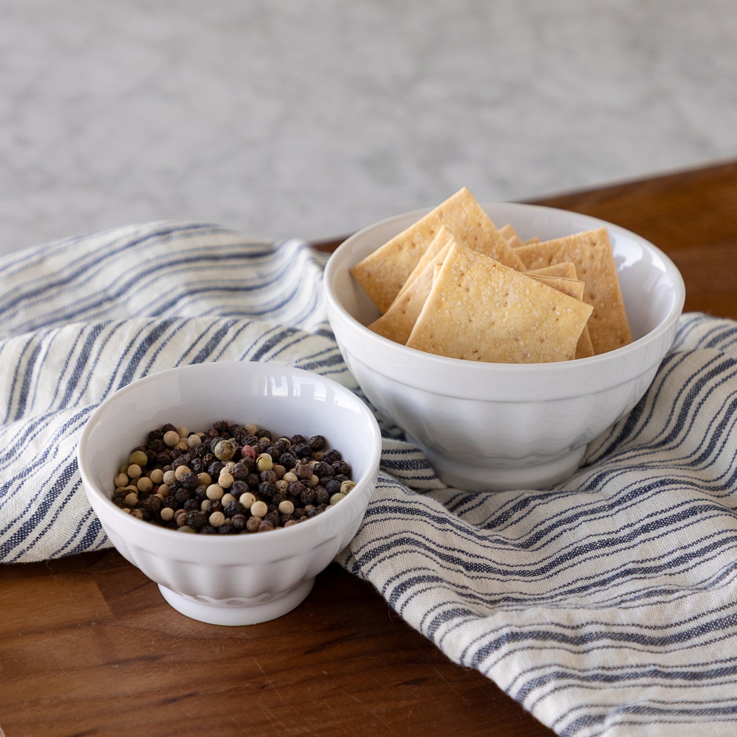 Porcelain Fluted Bowls with crackers and peppercorns. 