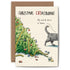 A toppled Christmas tree with scattered broken ornaments and a cat walking away. The card reads “Christmas CATastrophe” and “My work here is done.” indicating the cat&