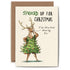 An illustration of a standing reindeer, posing with a Christmas tree dress on and the words "I&