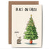 An illustration of a cat looking up at a Christmas tree with decorations at the top only and the words "Damn" indicating the cat&