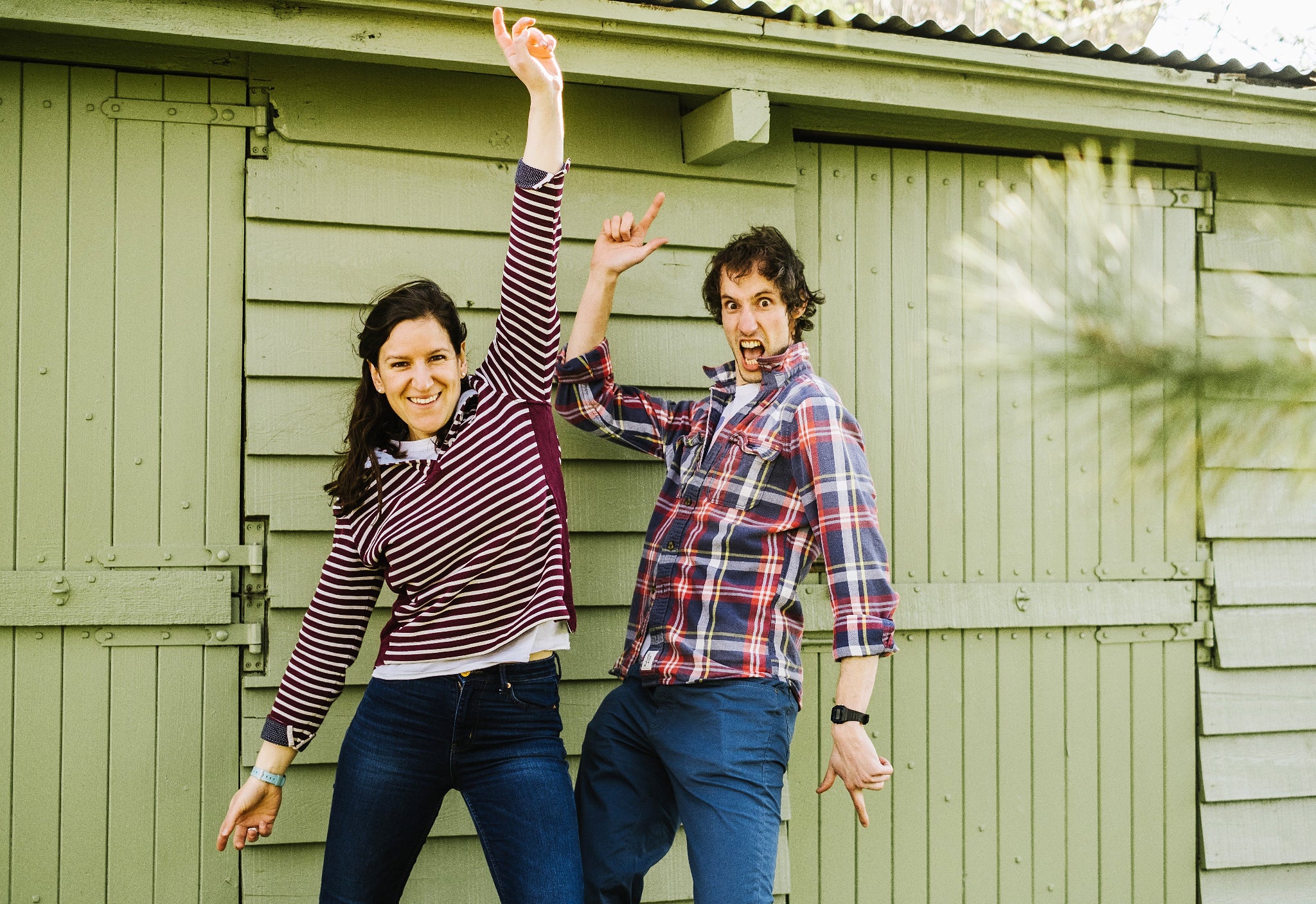 Maggie and Ian Hamilton from Bewilderbeest whimsically posing in front of a shed.