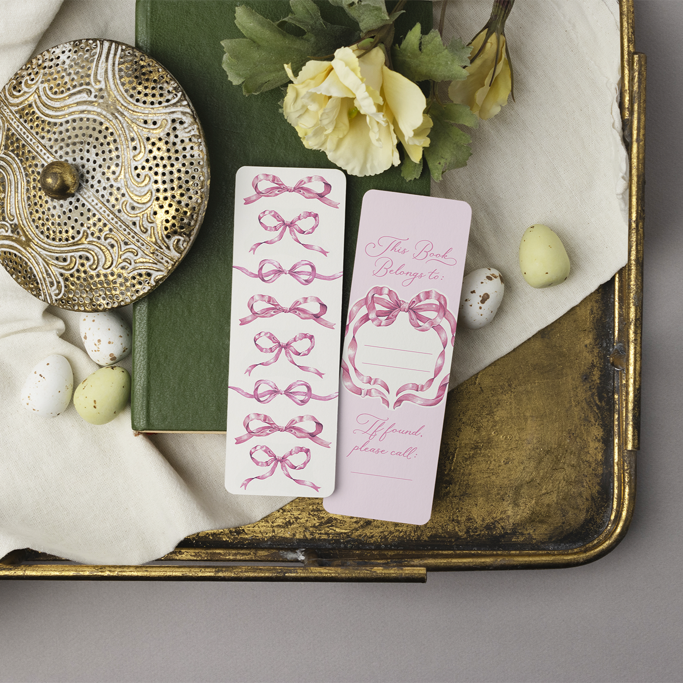 Two Pink Bow Bookmarks on a decorative tray featuring the front side and back side.