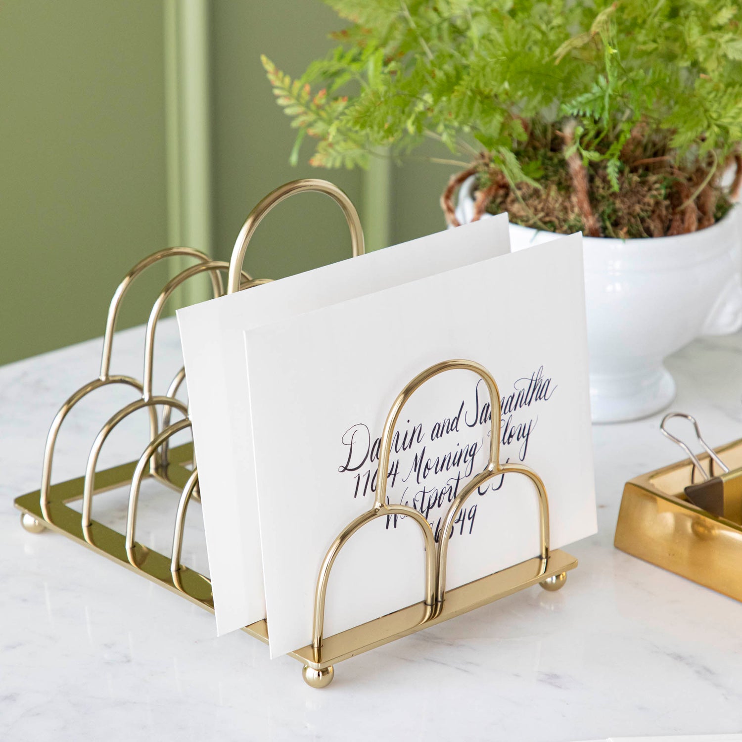 brass correspondence holder with letter in it