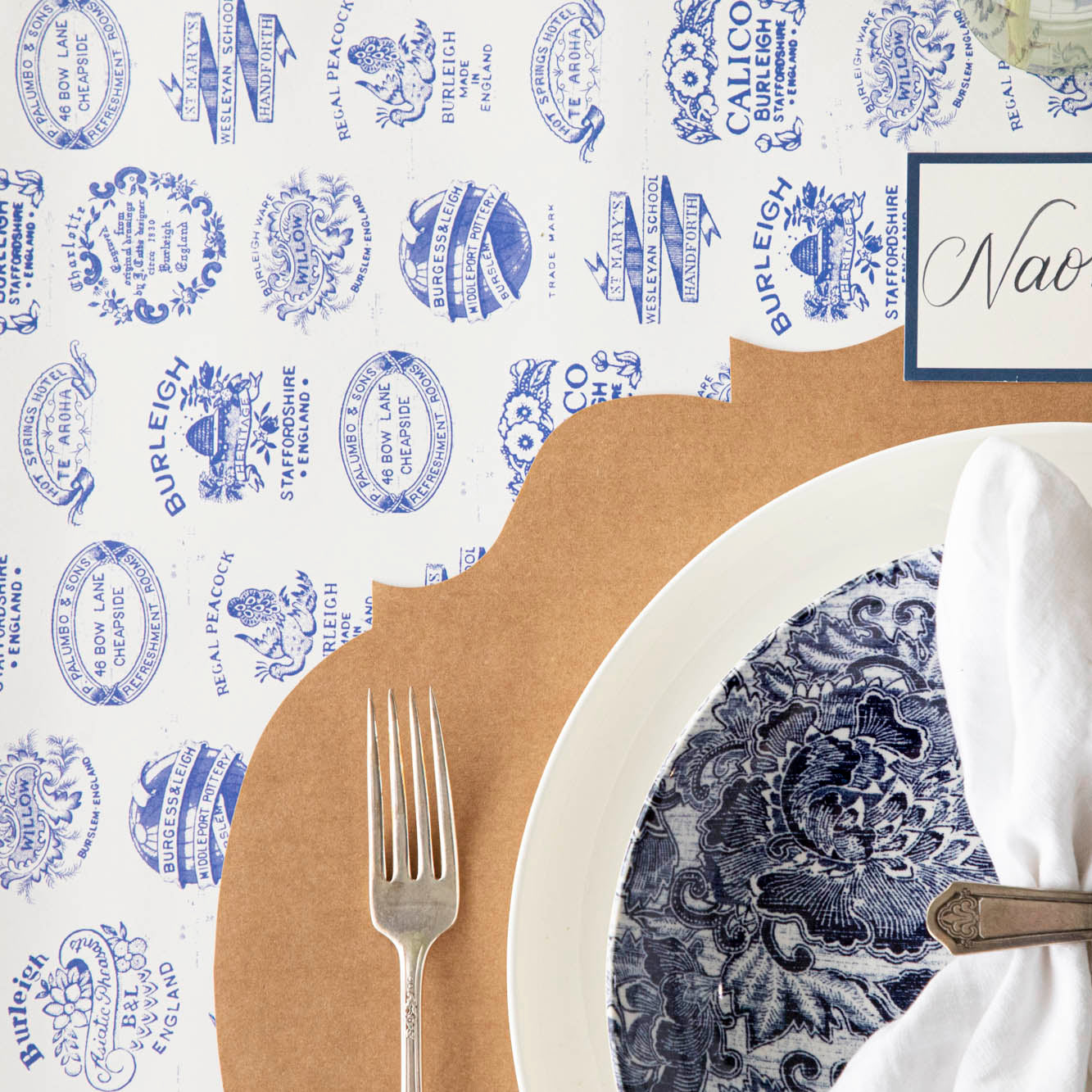 Burleigh Heritage Runner under the Kraft French Frame Placemat with an elegant place setting on top.
