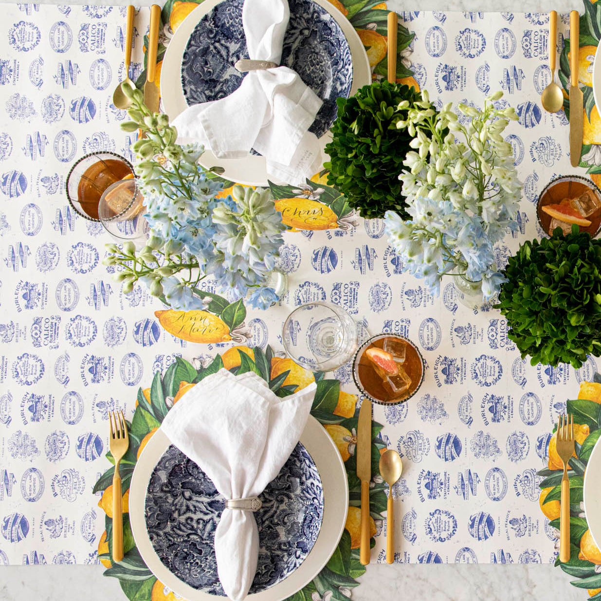 Burleigh Heritage Runner under the Die-cut Lemon Wreath Placemat with an elegant place setting for two on top.