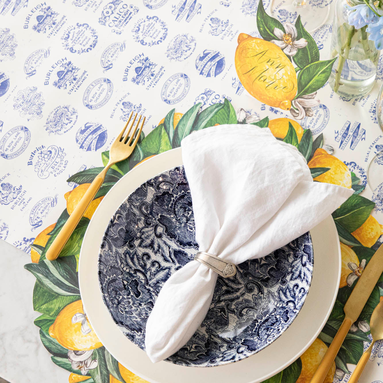 Burleigh Heritage Runner under the Die-cut Lemon Wreath Placemat with an elegant place setting on top.