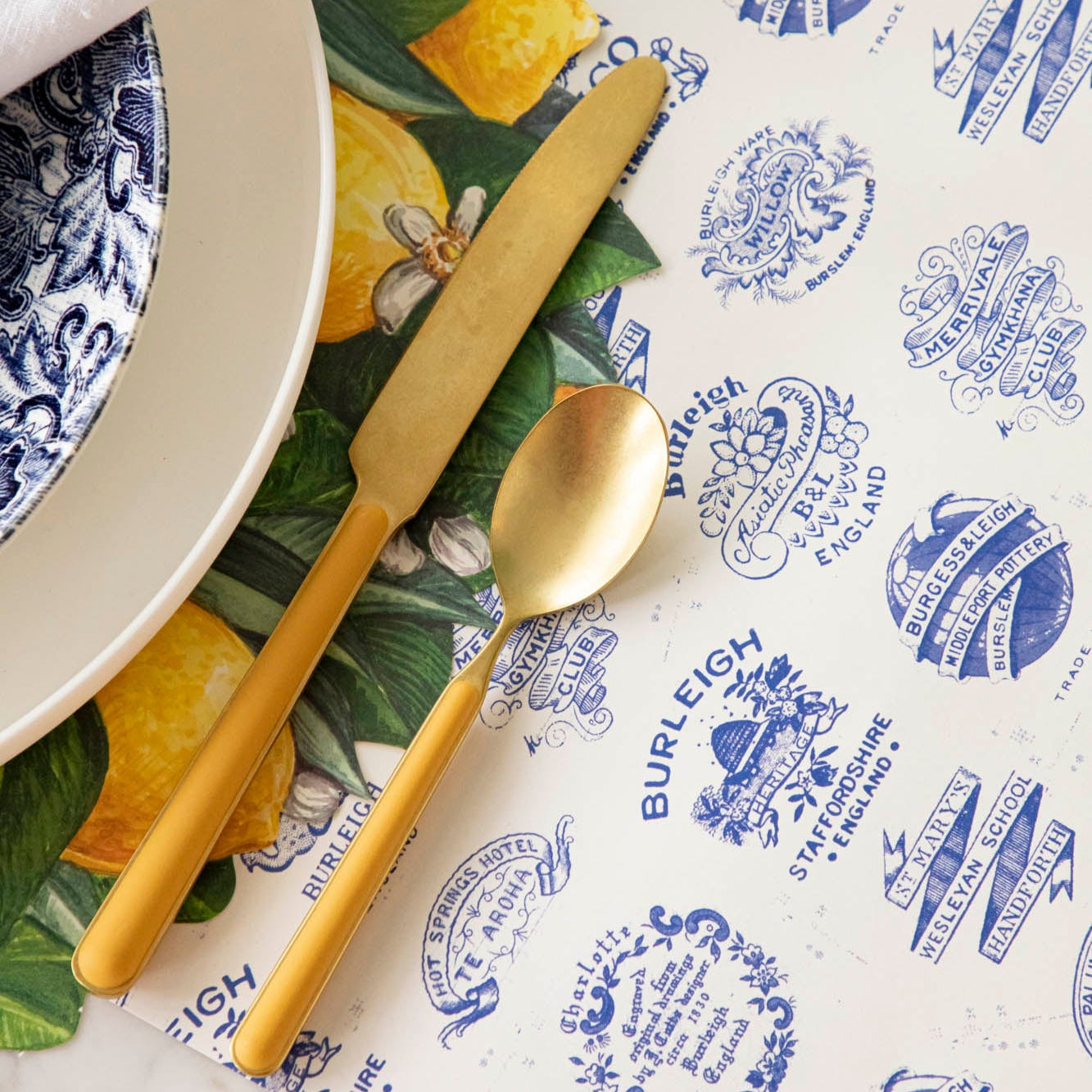 Burleigh Heritage Runner under the Die-cut Lemon Wreath Placemat with an elegant place setting on top.