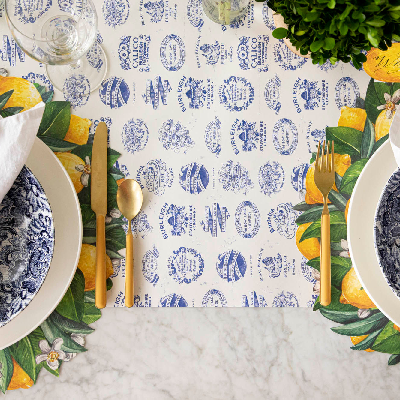 Burleigh Heritage Runner under the Die-cut Lemon Wreath Placemat with an elegant place setting on top.