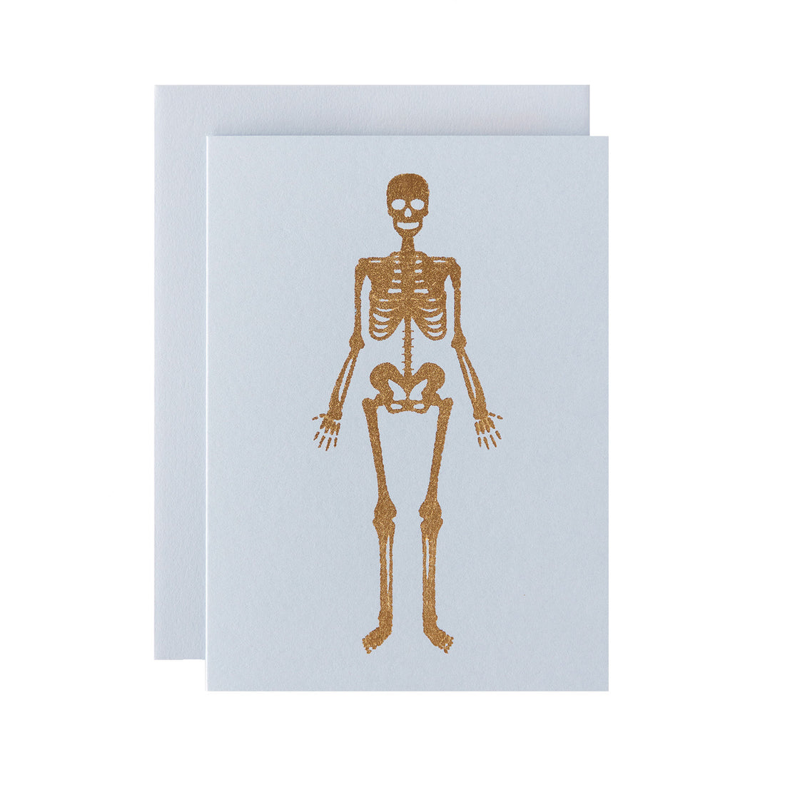 A gold foiled human skeleton on a light grey background, with a matching envelope.