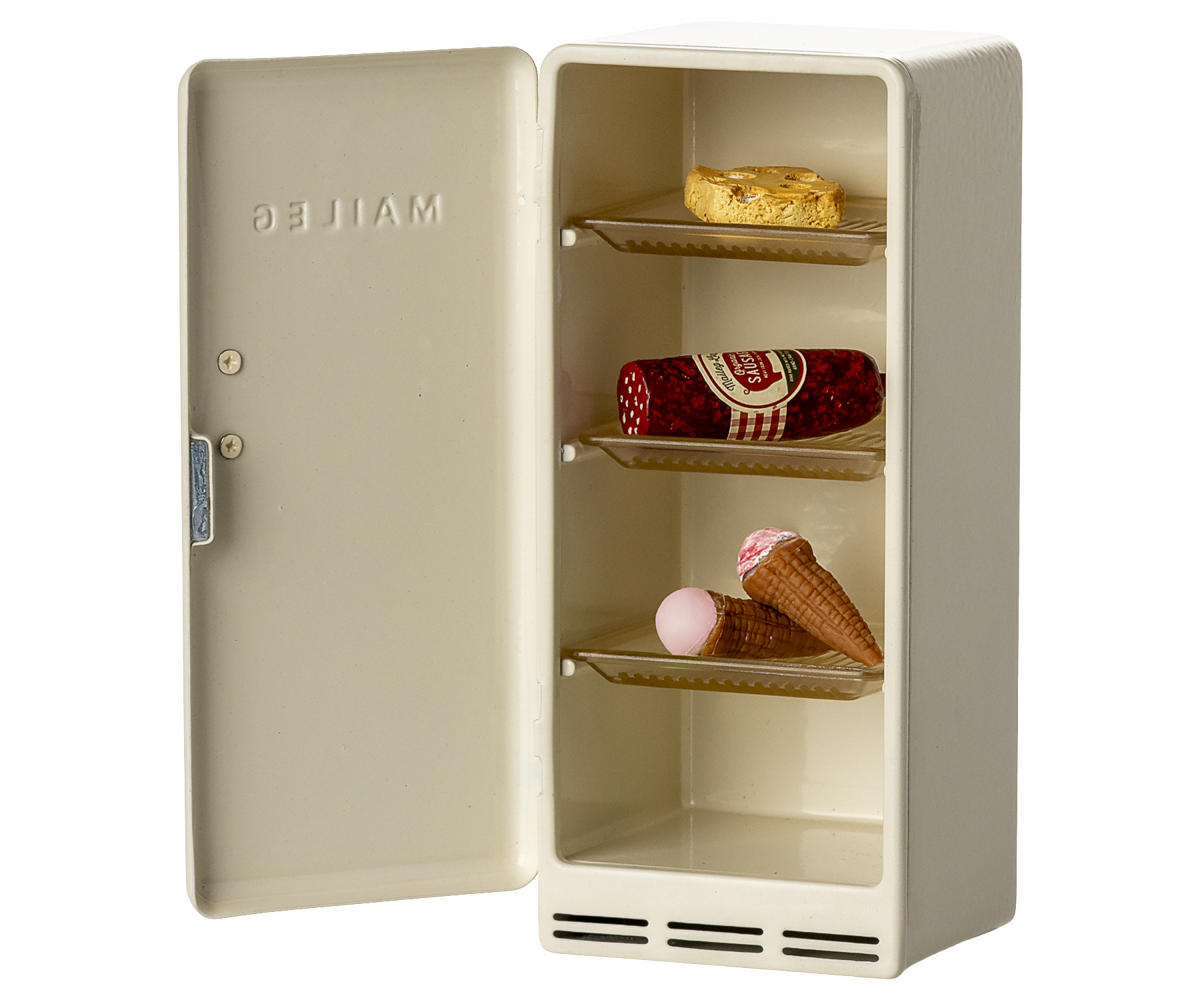 Small beige refrigerator with ice cream cones and a bottle inside on a white background.