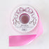 A spool of pink satin ribbon with a label featuring illustrated scissors and a pink bow, branded "Hester & Cook Fancy Pink Ribbon.