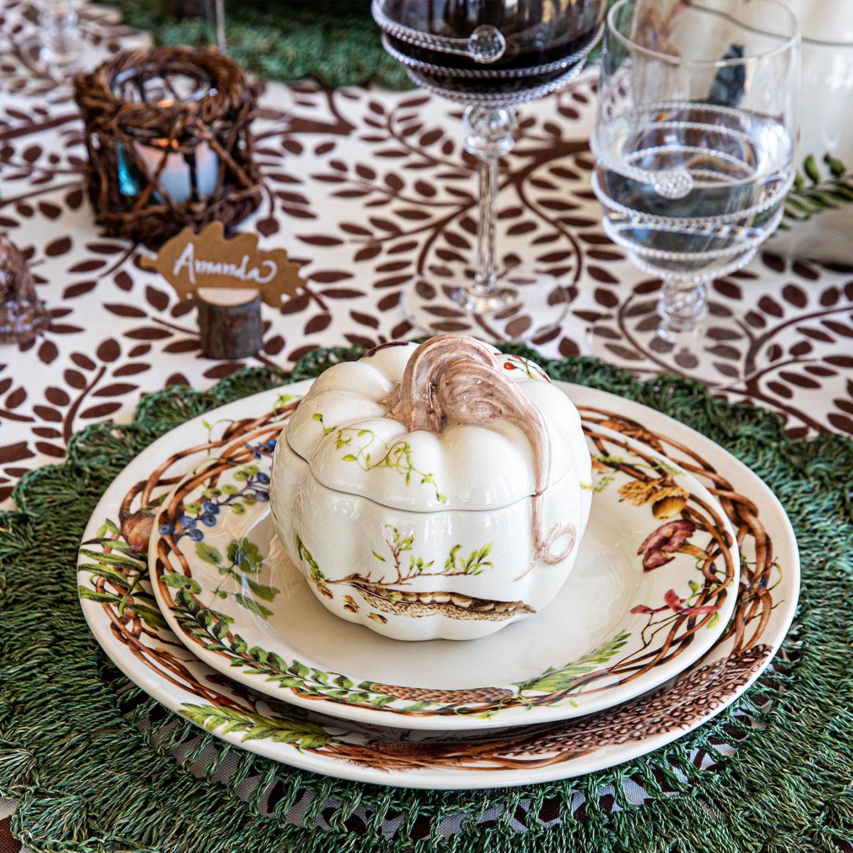 A table setting with Forest Walk Dinnerware from the Juliska Collection, silverware, and utensils.