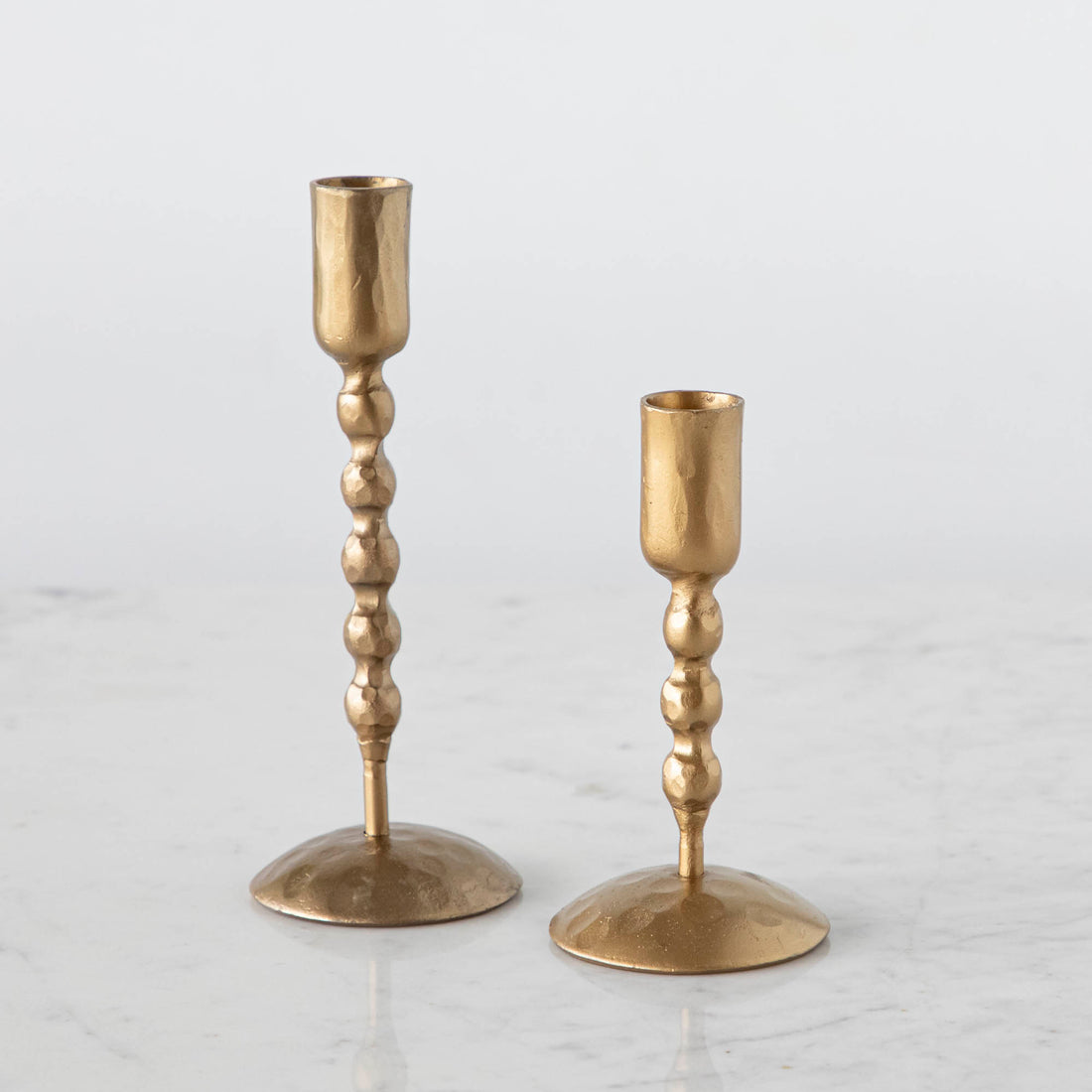 Set of tall and short twisted hand forged candle holders by Creative Co-op.