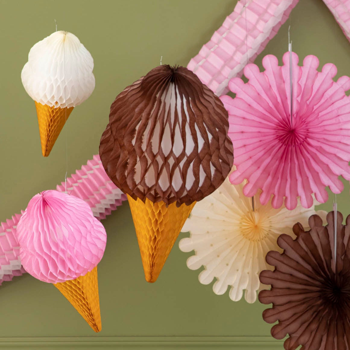 Honeycomb Strawberry and Vanilla Medium Ice Cream Cones on from the ceiling amongst other honeycomb.