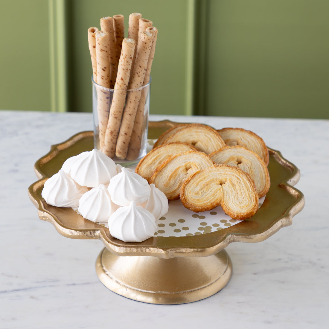Scalloped Edge Cast Aluminum Cake Plate with the Gold Confetti Serving Paper, palmiers, meringues, and a small cup of wafers atop.