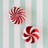 Two red and white striped Christmas ornaments on the Classic Seafoam Stripe Runner.