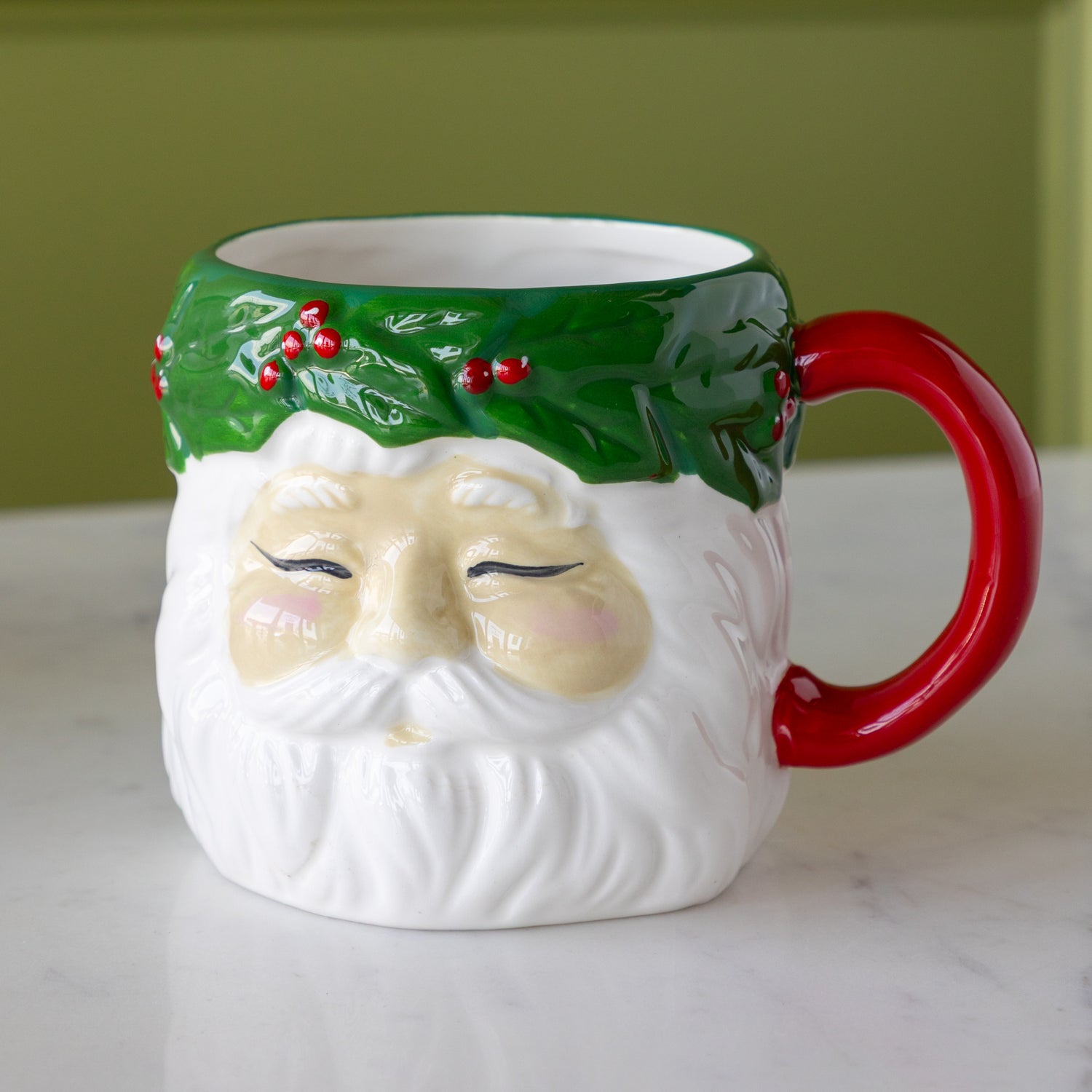 Vintage Santa with Wreath Mug on a marble table.