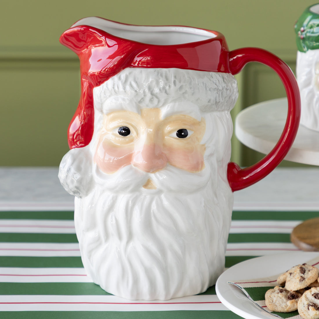 Vintage Santa Pitcher next to a plate of cookies on the Green & Red Awning Stripe Runner.