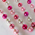 Pink & Silver Vintage Ornament Garland on a marble table.