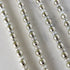 Close-up of Silver & Gold Bead Garland  on a marble surface. 