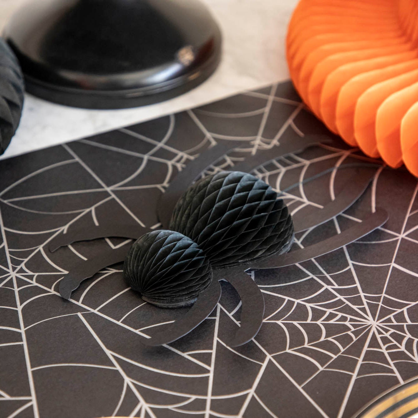 A honeycomb spider laying on the Spiderweb Runner.