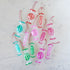 Colorful glass candy ornaments on a marble surface.