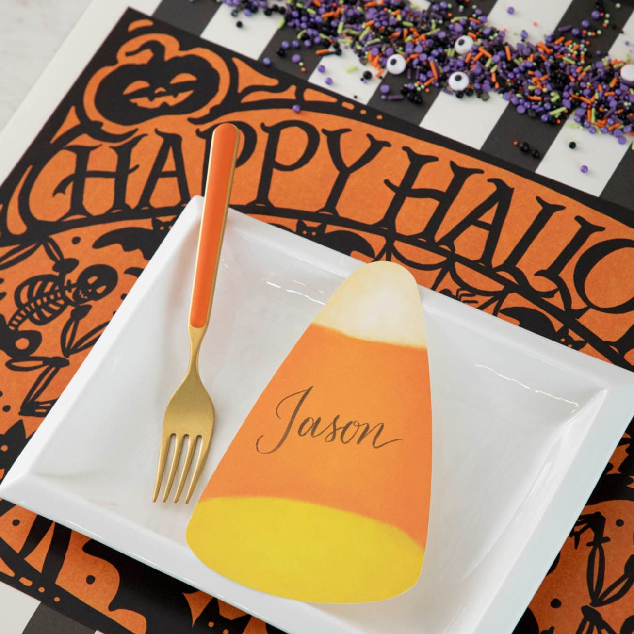 Wicked Halloween Placemat table set up with dinnerware and halloween themed sprinkles