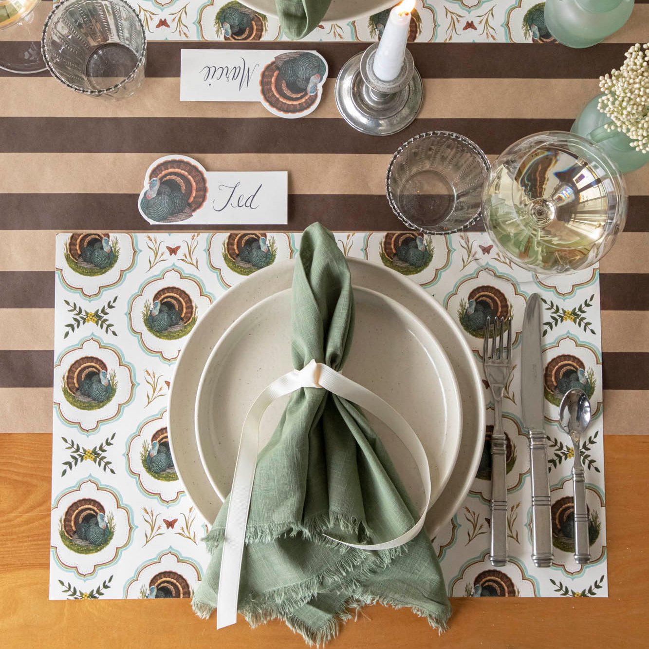 Elegant tablescape with the Heritage Turkey Meadow placemat, dinnerware, a a coordinating napkin.
