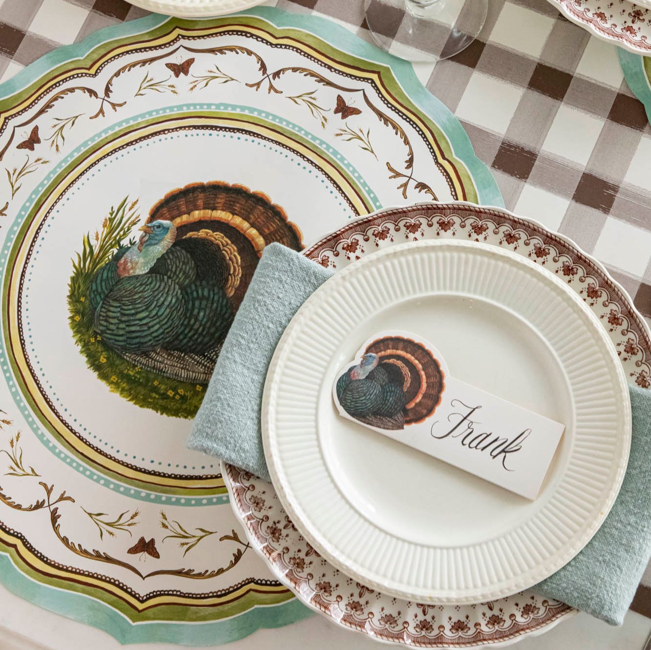 Die-cut Heritage Turkey China Placemat with dinner plates and a napkin on top.