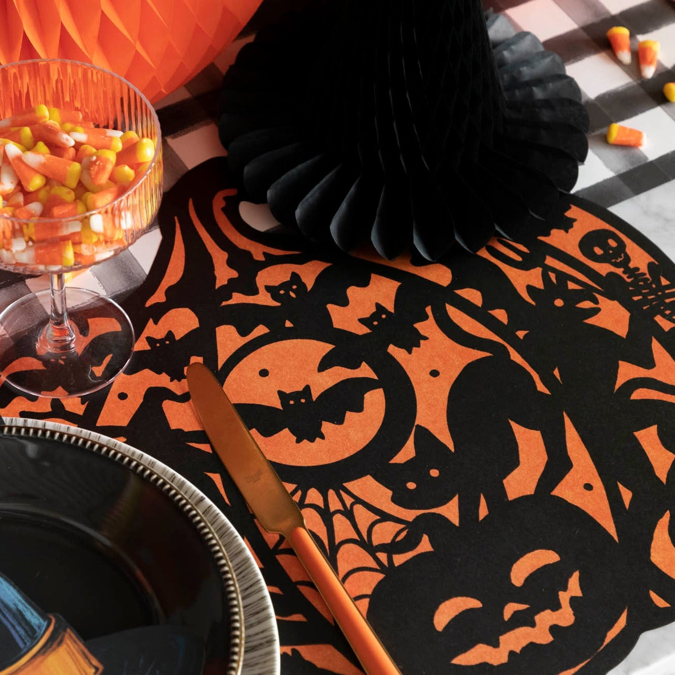 Close up view of the Die-cut Wicked Jack o Lantern Placemat with halloween themed decorations.