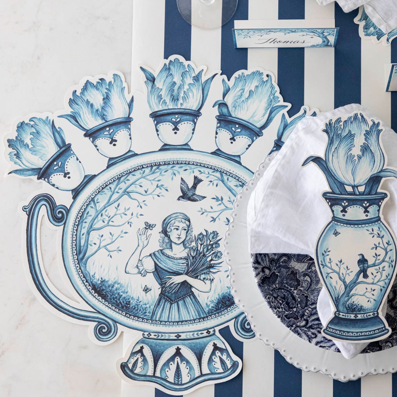 The Die-cut Indigo Meadow Placemat under an elegant place setting, from above.