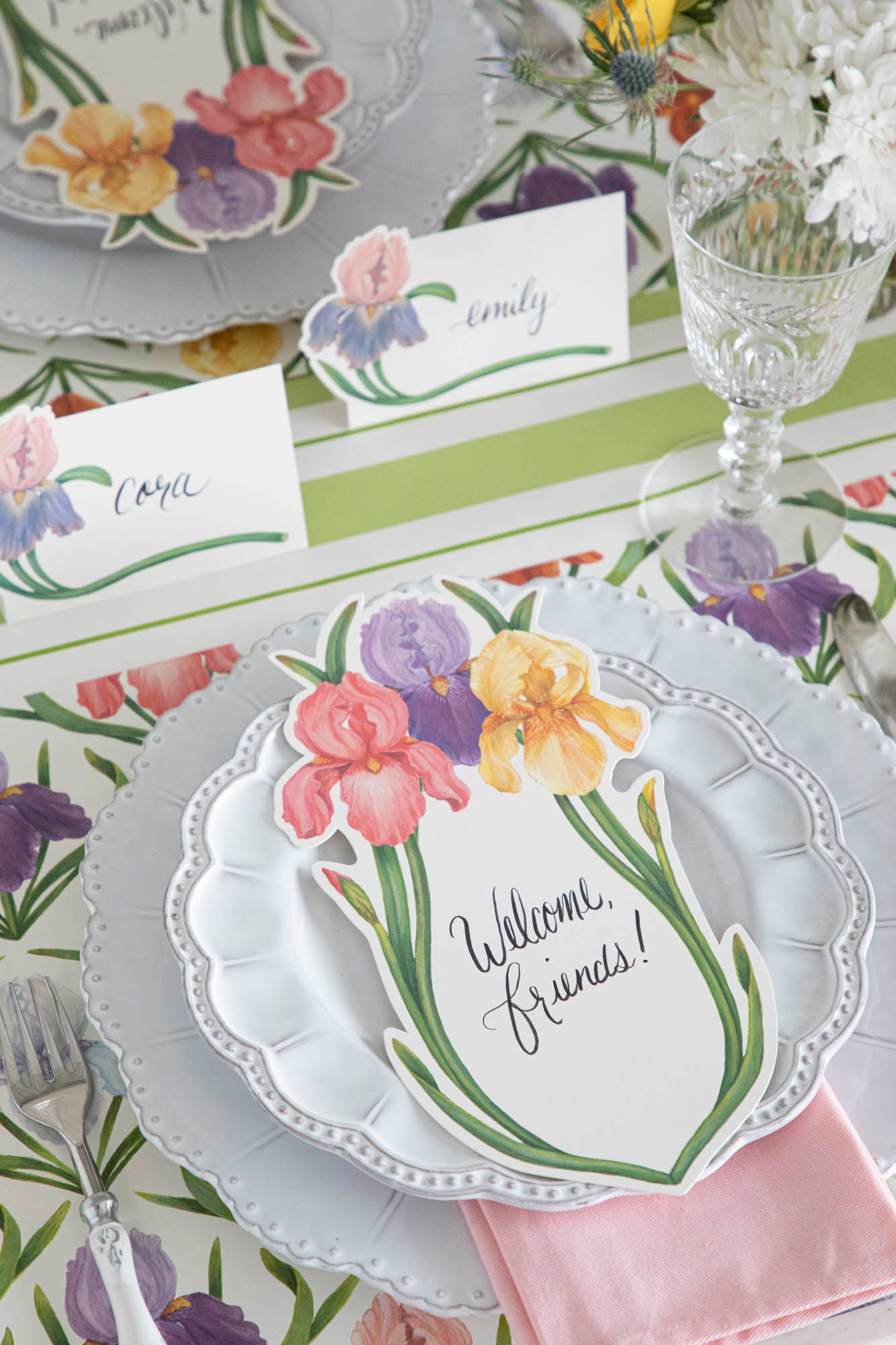 Top-down view of an elegant floral tablescape with Iris Place Cards at each place setting.