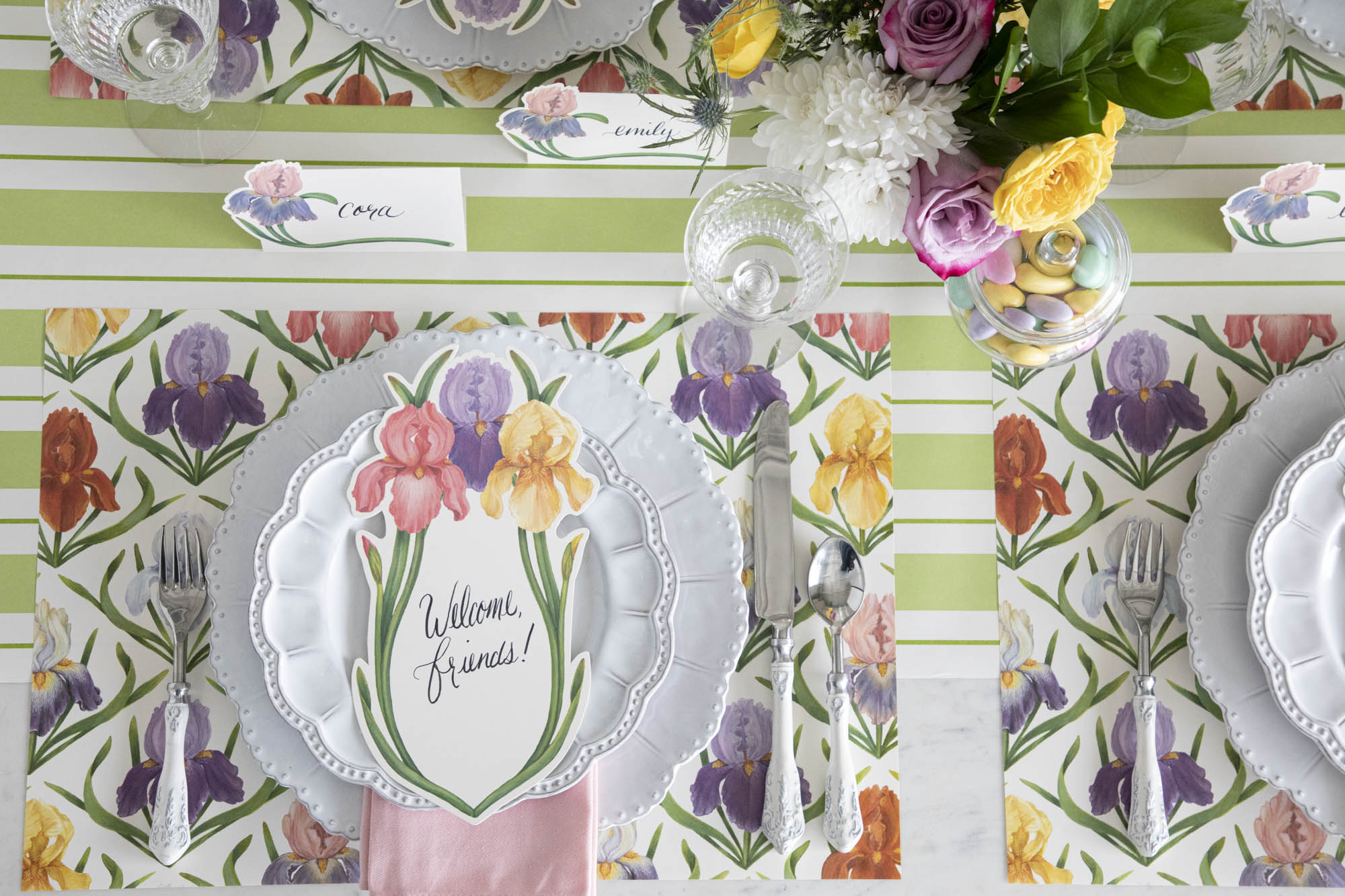 Top-down view of an elegant floral tablescape with Iris Place Cards at each place setting.