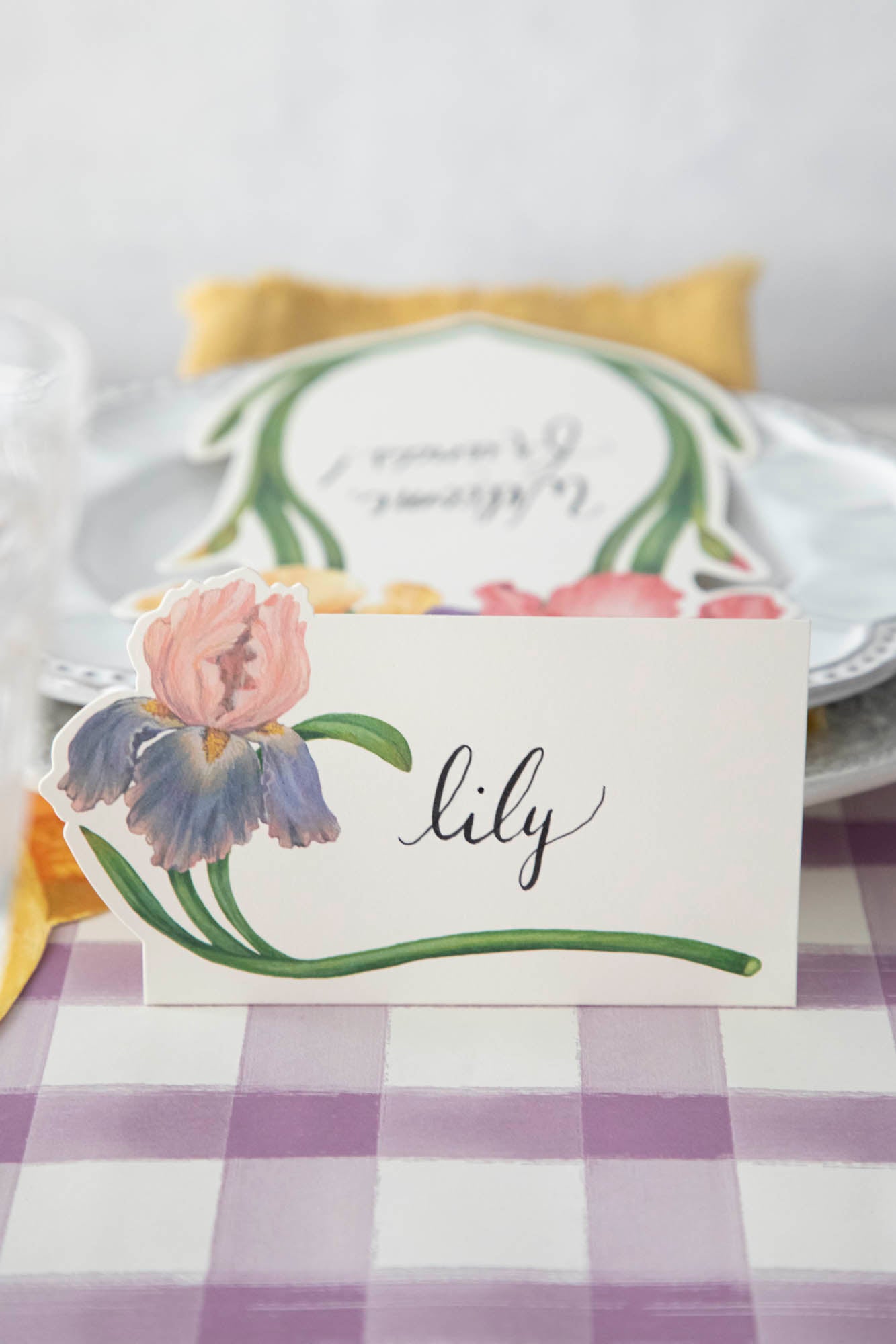 Close-up of an Iris Place Card reading "Lili" on an elegant springtime tablescape.