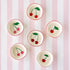 Six ceramic cherry pinch bowls with red rims and charming cherry illustrations inside, arranged on the Pink Classic Stripe Runner.