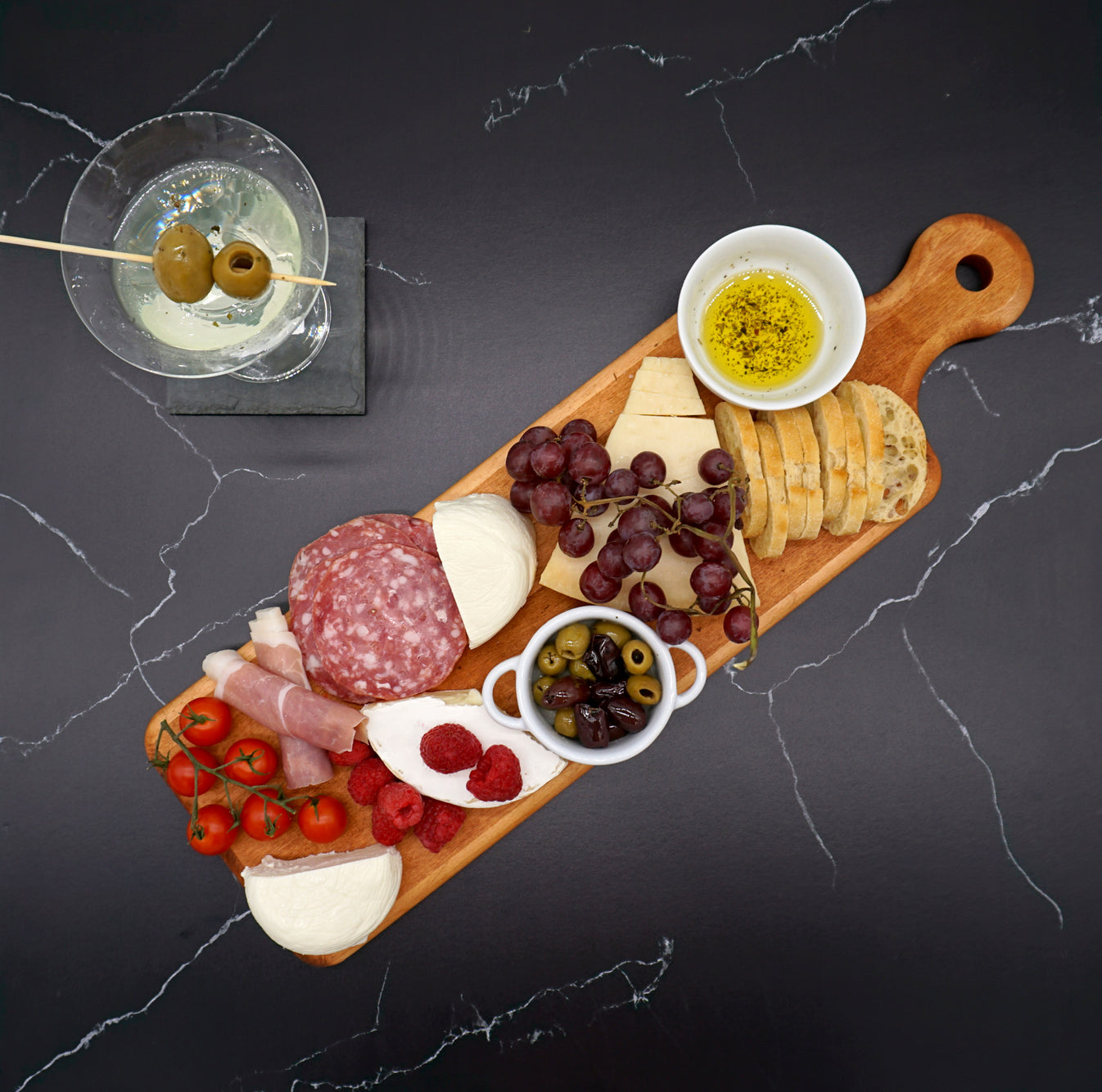 Maple Artisan Plank Serving Board with charcuterie on top and a martini next to it.