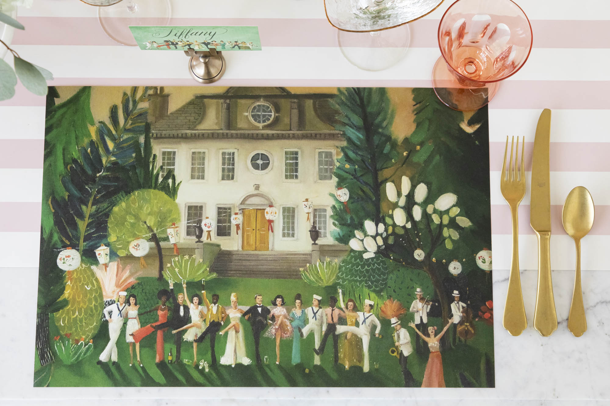 A High Kick Placemat resting on a table with no plate on it, showing the festive artwork, from above.