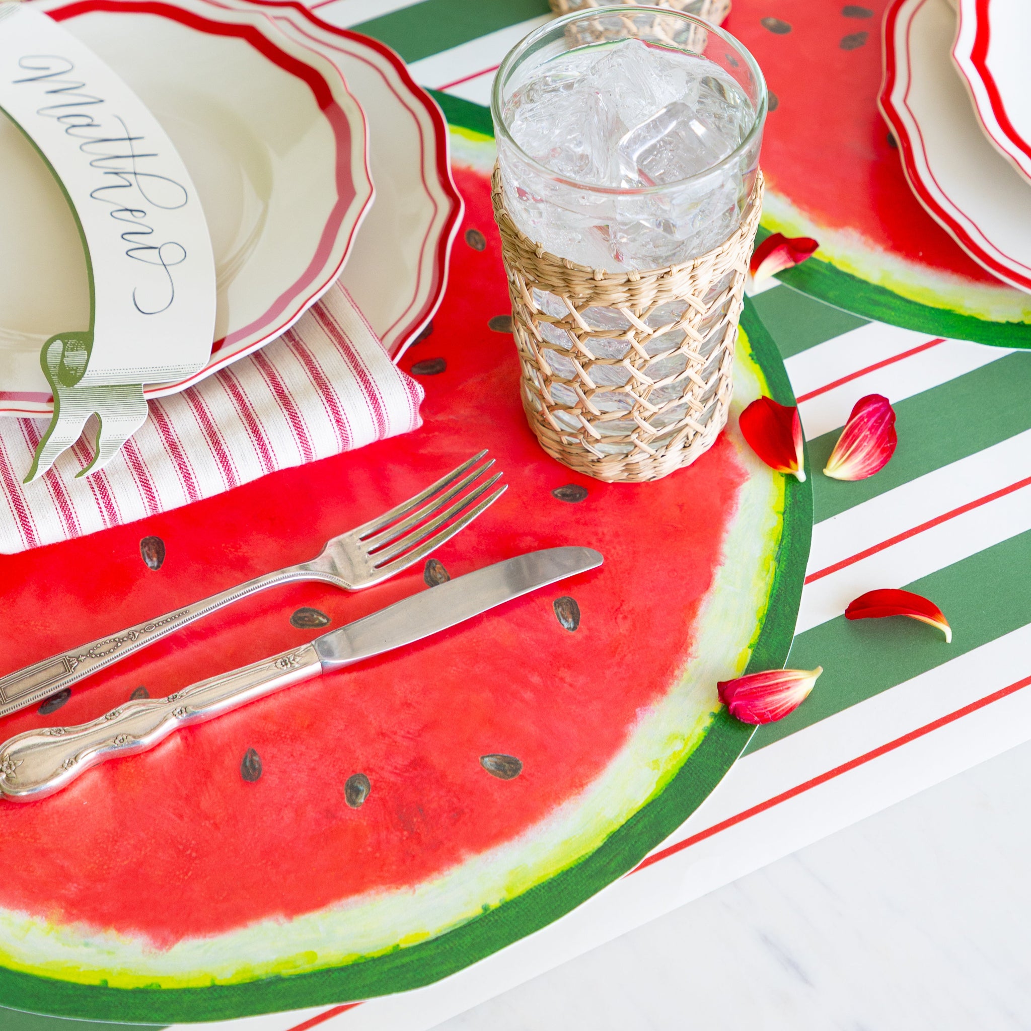 Table setting with Die-cut Watermelon Placemat, glasses, and cutlery on the Green & Red Awning Stripe Runner.
