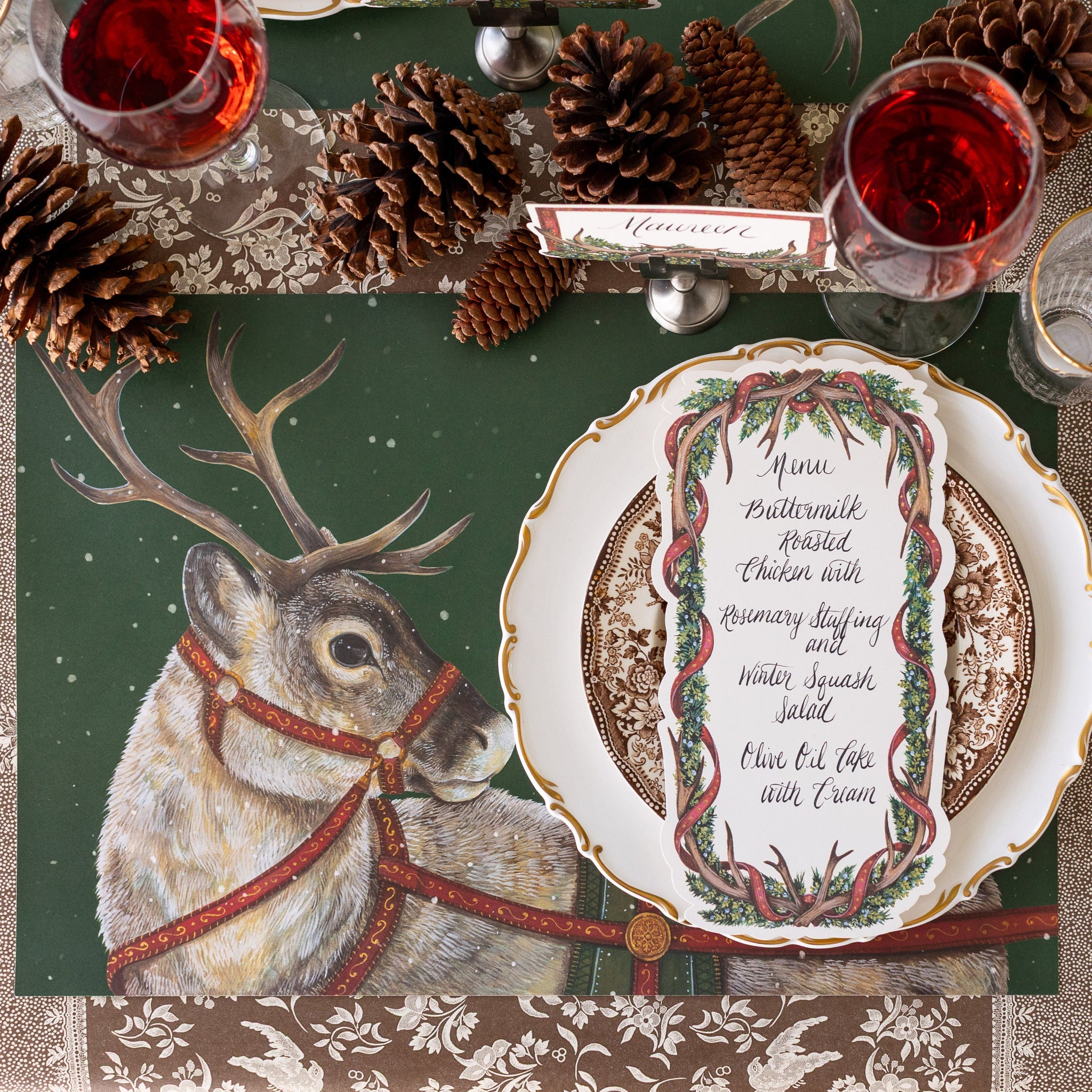 Christmas-themed table setting with the Holiday Reindeer Placemat, Antler Garland Table Card and festive decor.