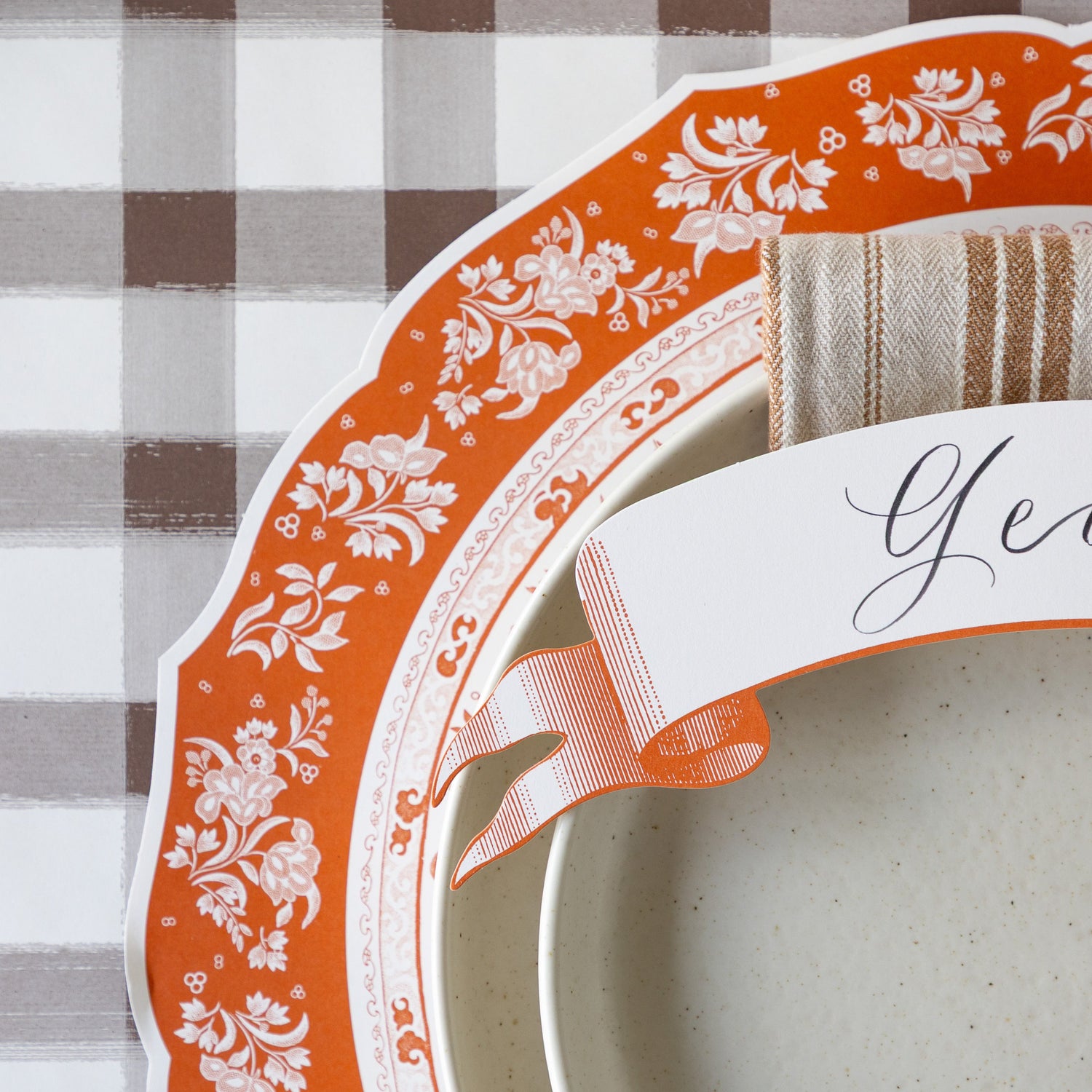 The Die-cut Pumpkin Regal Placemat under an elegant place setting with the Brown Painted Check Runner underneath.