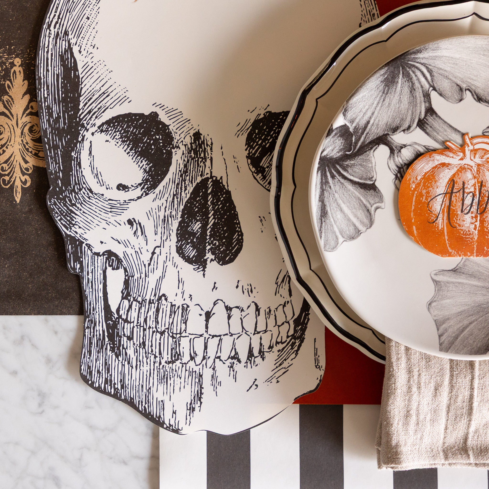 A close up of the Die-cut Skull Placemat under a place setting.