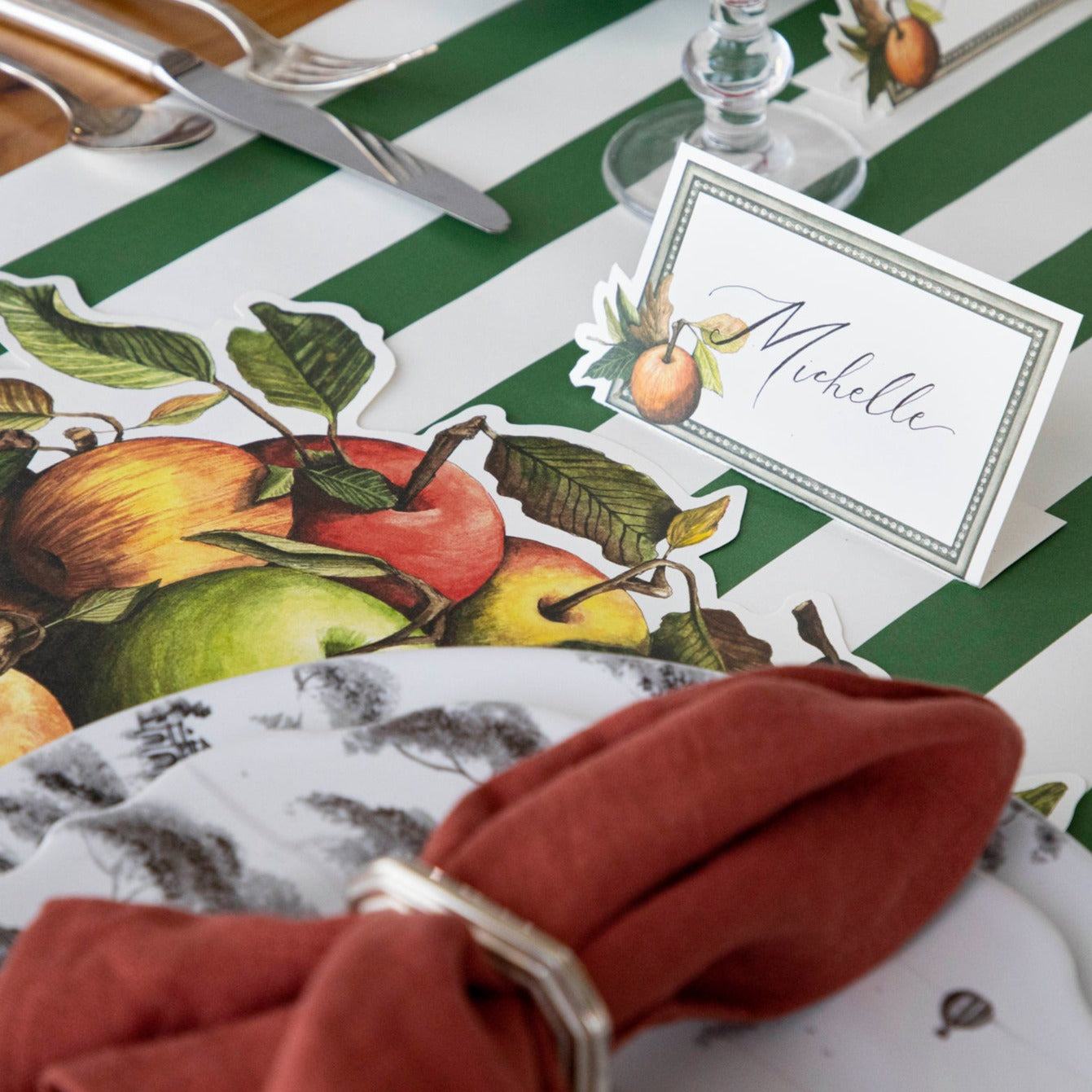A place setting featuring a Heirloom Apples Place Card labeled "Michelle".