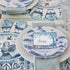 A table setting with blue and white Juliska Country Estate Delft Blue Dinnerware dinner plates and napkins.