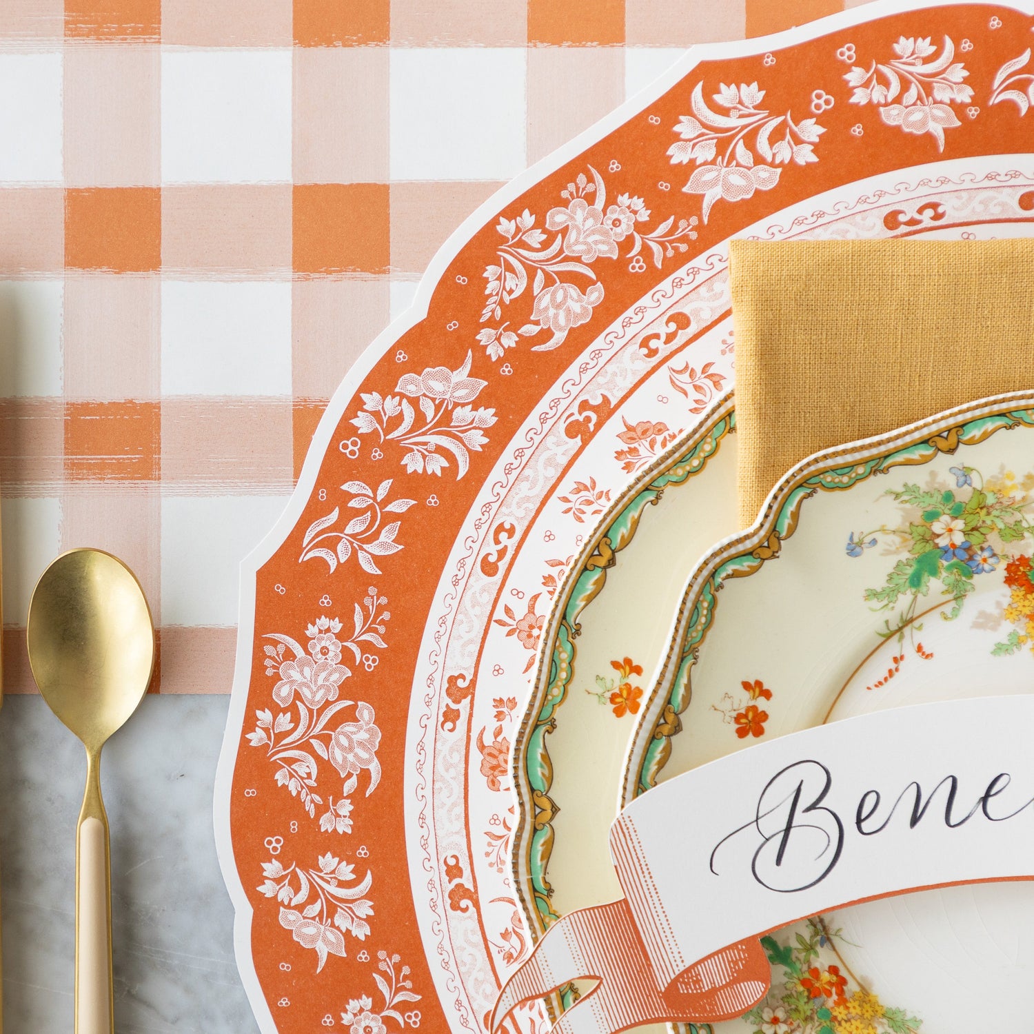 The Die-cut Pumpkin Regal Placemat under vintage floral dinnerware and Orange Classic Banner Table Accent, on the Orange Painted Check Runner.