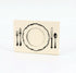 A white, rectangular freestanding place card featuring black artwork of an ornate plate with cutlery on either side.