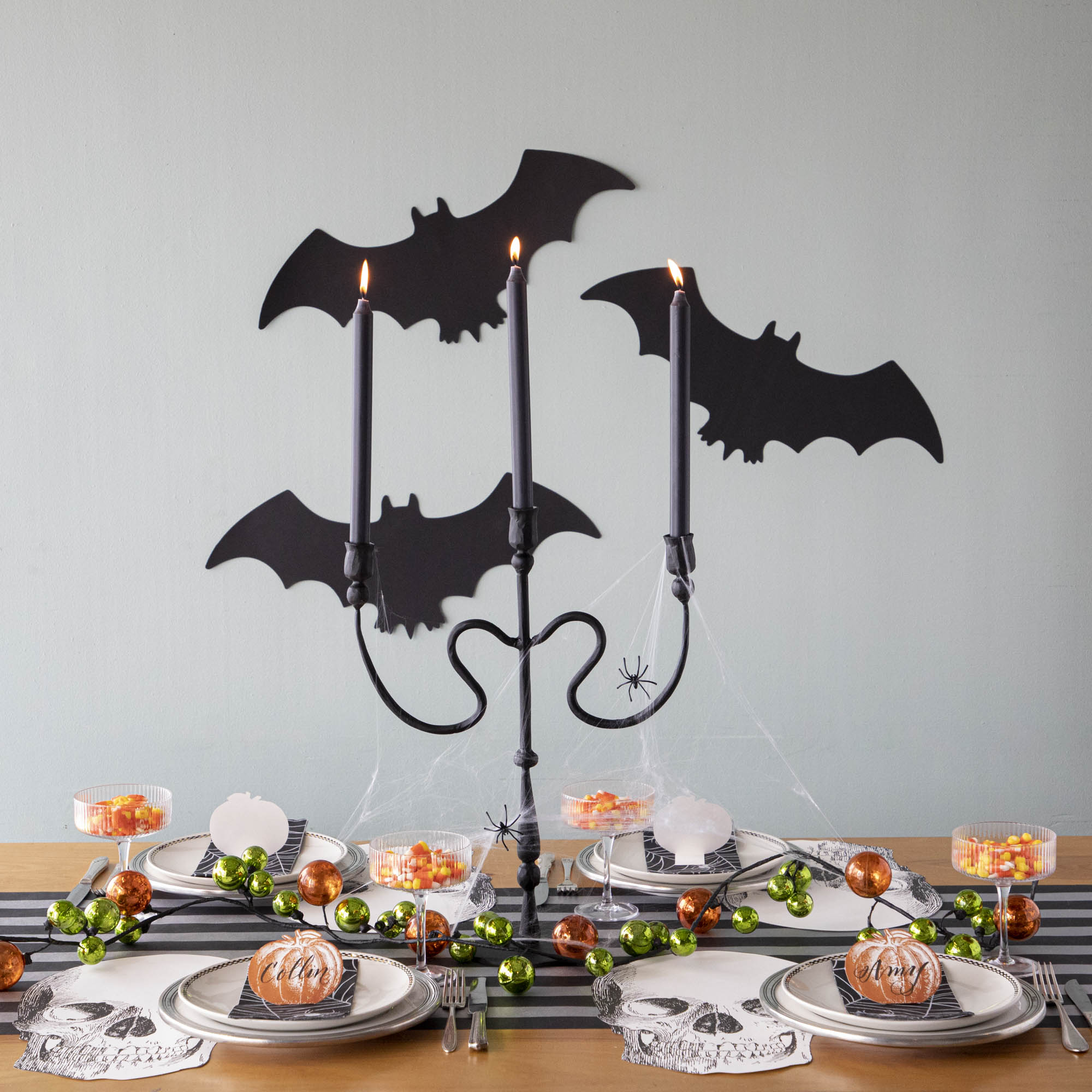 Halloween themed tablescape with die-cut silhouette bats on the wall.