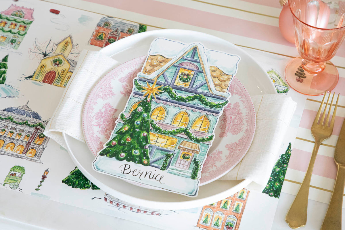 An elegant Christmas place setting featuring a Townhome Table Accent labeled &quot;Bernice&quot; resting on the plate.
